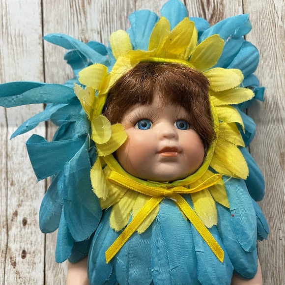 Collectible Porcelain Baby Doll Dressed in a Blue & Yellow Flower Costume - Picture 4 of 10